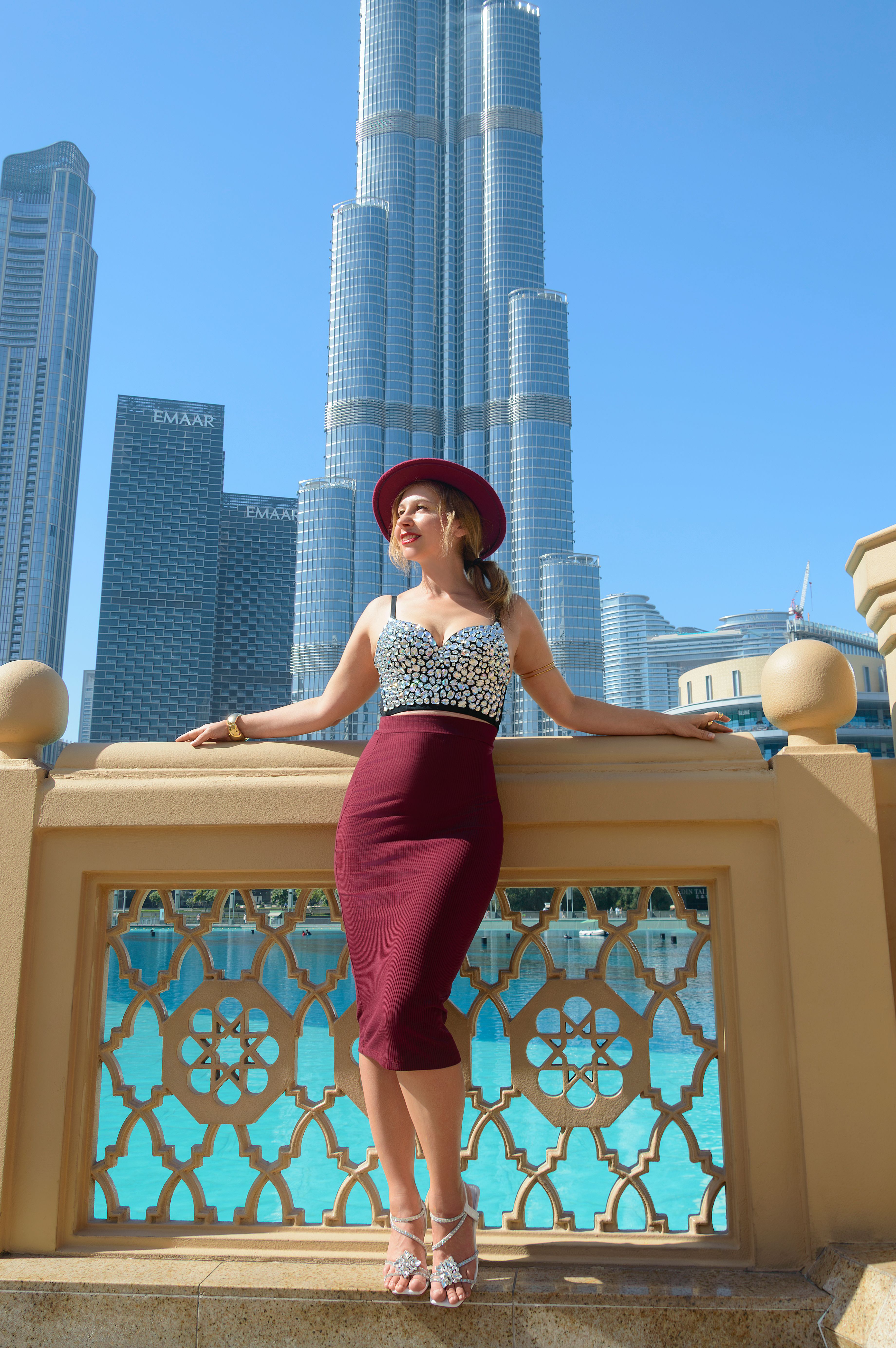 A traveler posing in front of Burj Khalifa to represent city and culture experiences in Dubai.