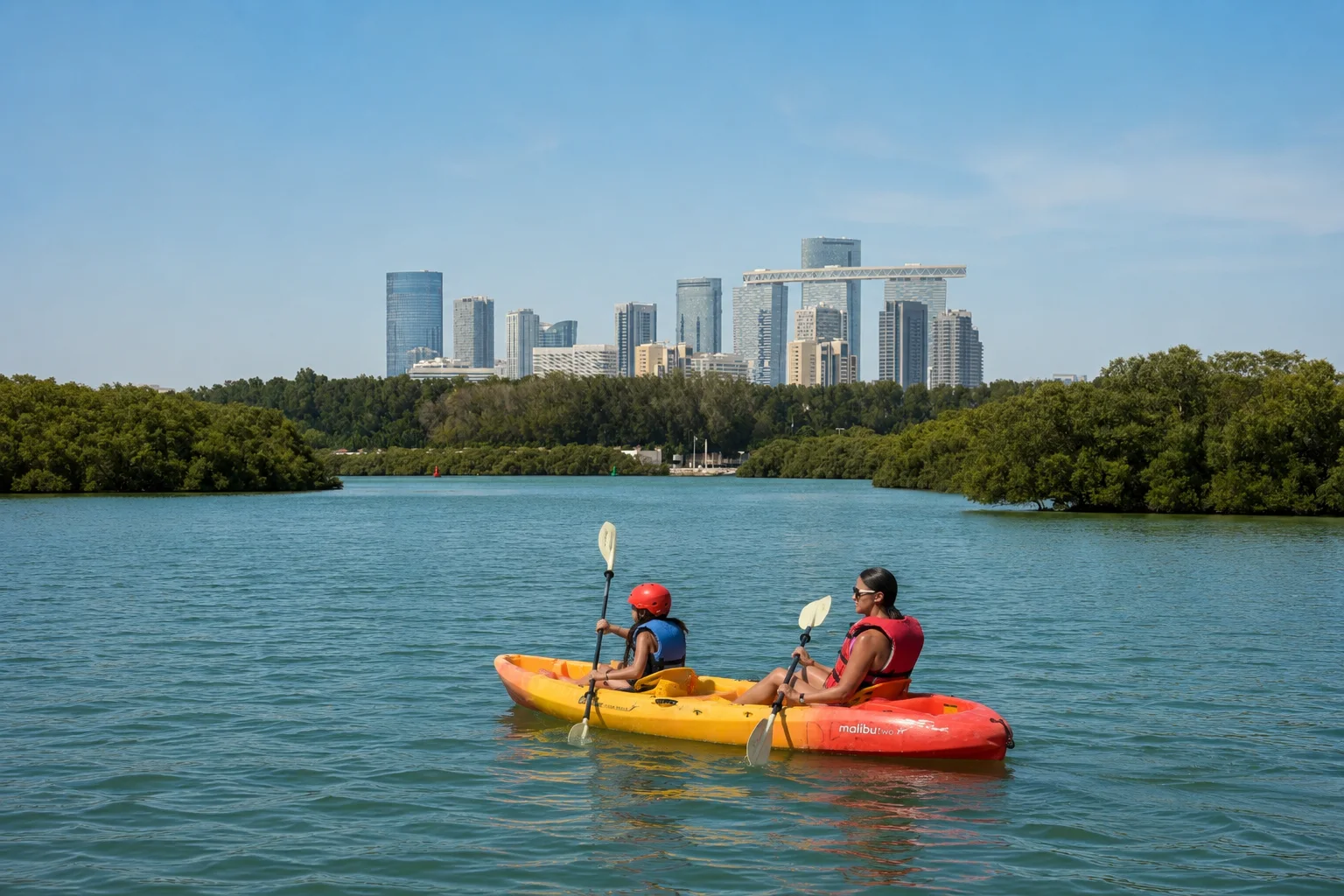 A kayaker paddling a red kayak on calm water