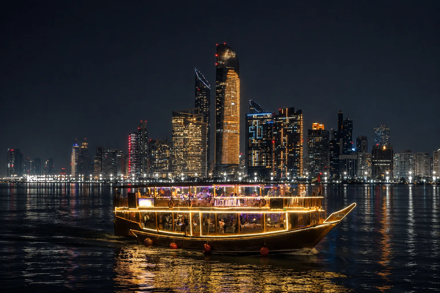 A lit dhow dinner cruise on the water at night